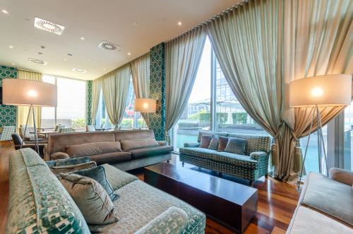 a living room with couches and a large window at Olissippo Oriente in Lisbon