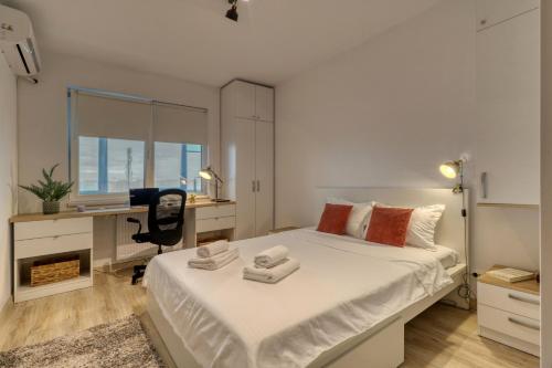 a bedroom with a bed and a desk with a computer at Homie Studio Apartment - Private Parking - Self Check-In in Bucharest