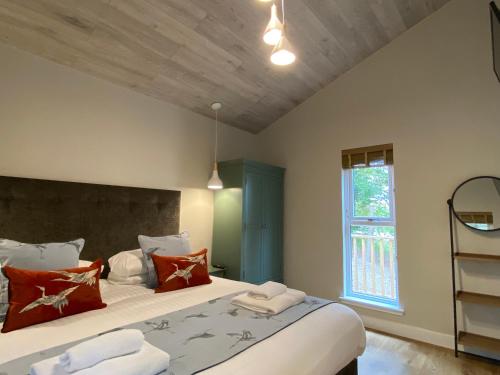 a bedroom with two beds and a window at Conker Lodge with Hot Tub in Cupar