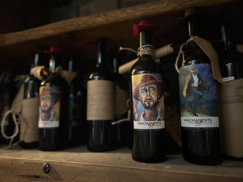 a group of bottles of wine on a shelf at Machanents Art Hotel in Vagharshapat