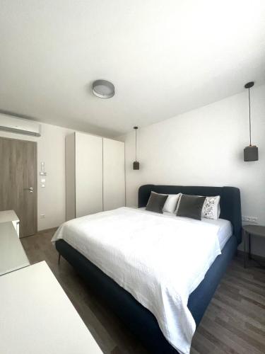 a bedroom with a large white bed in it at MT Suites ApartHotel in Budapest