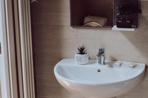 a bathroom with a white sink and a mirror at [Historic Center] Charming Apartment Free Wi-Fi in Savigliano
