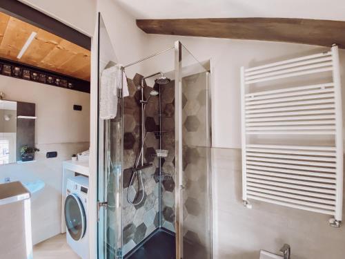 a shower with a glass door in a bathroom at [Historic Center] Charming Apartment Free Wi-Fi in Savigliano