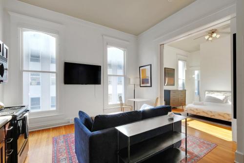 a living room with a couch and a bed at Historic Guthrie Coke Lofts, Downtown Louisville in Louisville