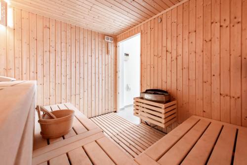 a wooden room with a sauna with a tub at Seafront Villa Layla by Ruidoso Luxury in Ayia Napa
