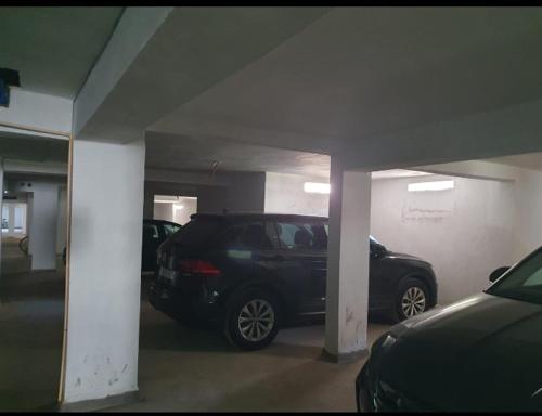 a parking garage with two cars parked in it at Appt a 500 m de la plage in Douar Ourlali