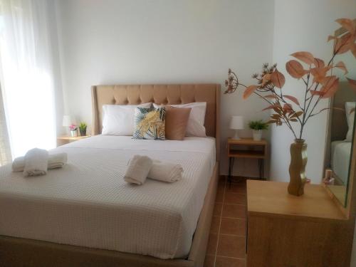 a bedroom with a bed with two towels on it at Anna's Cozy Flat in Lefkada
