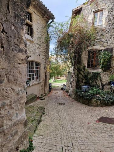 an alley in an old stone building at Gite de charme La Martinelle in La Bégude-de-Mazenc