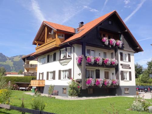 a building with flower boxes on the side of it at Haus Eggensberger in Fischen