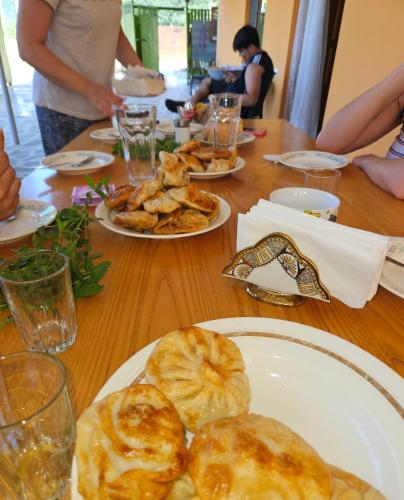 a wooden table with plates of food on it at Guest house lagodekhi in Lagodekhi