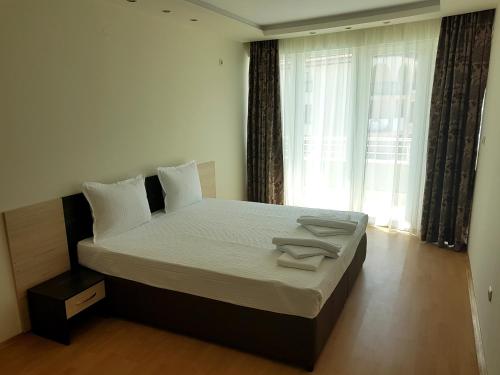 a large bed in a room with a large window at Sinemorets Cliffs in Sinemorets