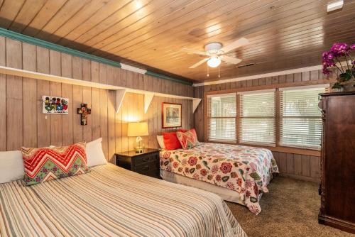 1 Schlafzimmer mit 2 Betten und einem Deckenventilator in der Unterkunft 4 Bedroom Retreat with Game Room and Creek Access in Pawleys Island