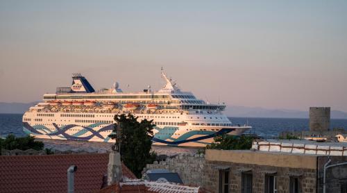 a cruise ship is docked in the ocean at DECAN Concept Boutique Estate in Rhodes Town