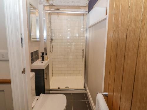 a small bathroom with a toilet and a shower at Whitehedge in York