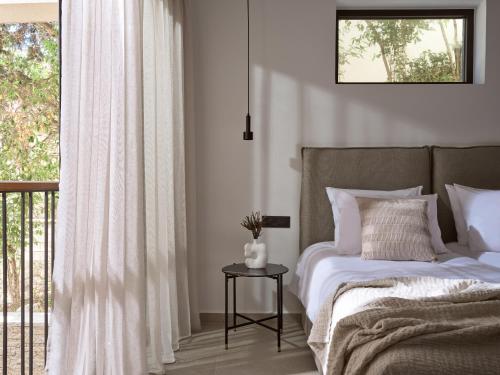 a bedroom with a bed and a window at Salita - Comfort Living Apartments in Zakynthos Town