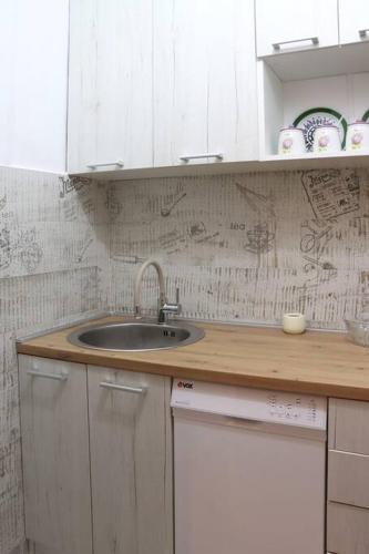 a kitchen with a sink and white cabinets at Platanus in Trebinje