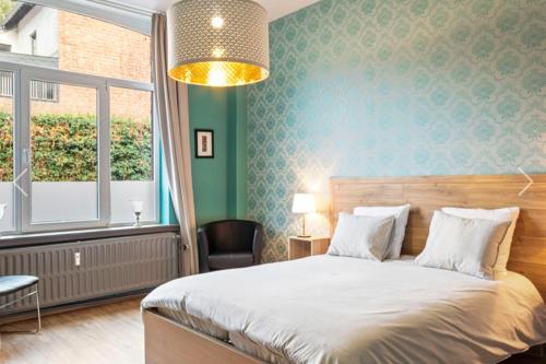 Ένα ή περισσότερα κρεβάτια σε δωμάτιο στο Au cœur de Dinant