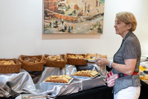 a woman standing in front of a table of food at Blue Sea Le Printemps in Marrakech