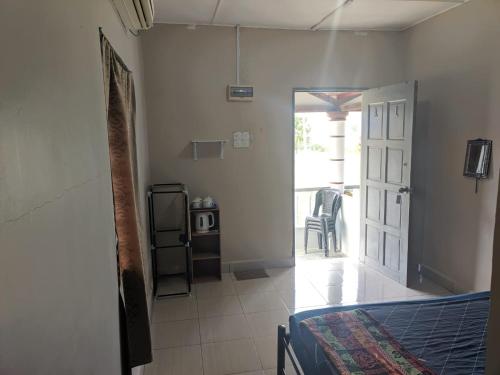 - une chambre avec un lit et une porte donnant sur une terrasse dans l'établissement Mersing Chalet Teluk Sisek, 