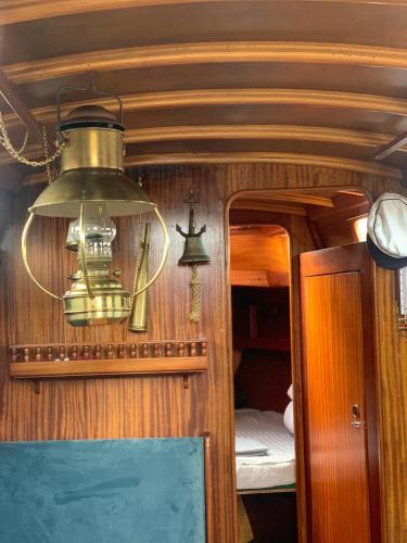 a chandelier hanging from a ceiling in a room at Pāvilostas_laivas in Pāvilosta