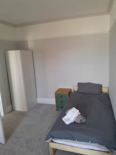 a bedroom with a bed and a dresser in it at Conveniently located, newly refurbished flat (sleeps 4) in Pembrokeshire