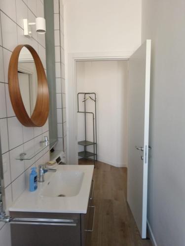 a bathroom with a sink and a mirror at La casetta di Cecilia in Trani