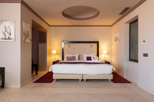 a bedroom with a large white bed with a large mirror at Blue Sea Le Printemps in Marrakech