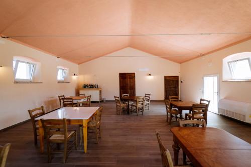 a dining room with wooden tables and chairs at Agriturismo Bio Podere 109 in Alberese