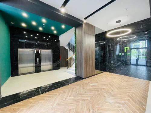 a store lobby with a wooden floor and black walls at The Palm 2 Apartment - family friendly, central, self check-in in Oradea