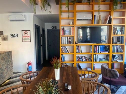a dining room with a table and a book shelf at Wolf Of The City Hotel & Spa in Antalya