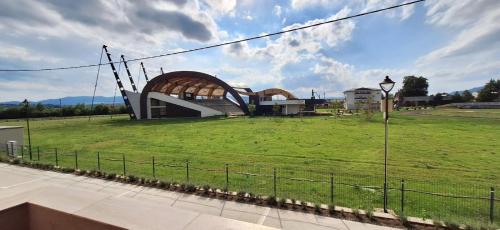 a building in a field with a green field at CITADEL VIEW in Tîrgu Neamţ