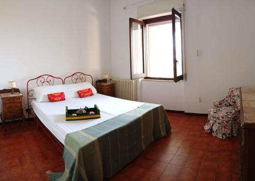 a bedroom with a large bed with red pillows on it at La Buganvillea in Marina Porto