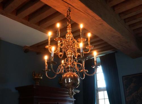 a chandelier hanging from a ceiling in a room at Château de La Rivière in Pontgouin