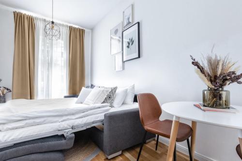 a bedroom with a bed and a table at TurnKey I Cozy Studio by Letna Park in Prague