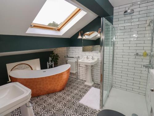 a bathroom with a bath tub and a sink at Lee House Farm in Halifax