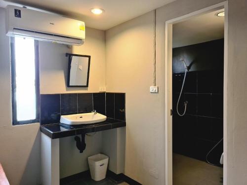 a bathroom with a sink and a mirror at The 8 Factory Hotel Phitsanulok in Phitsanulok