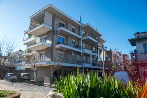 a tall apartment building with balconies and plants at Elpidas houses 2 Private parking Near city centre in Thessaloniki