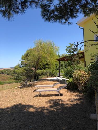 a group of picnic benches in a park at Il Giardino di Elettra in Palmadula