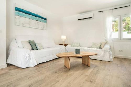 a living room with two white couches and a coffee table at Villa with private heated Pool by the beach & port - Benalmadena by REMS in Benalmádena