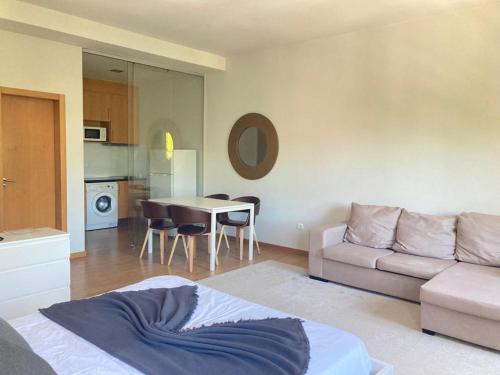 a living room with a couch and a table at Coreto Bento Freitas in Vila do Conde