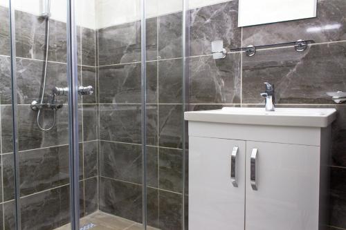 a bathroom with a shower and a sink at Long Beach Rental Apartments in Yeni Iskele