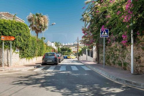a street with cars parked on the side of the road at Villa with private heated Pool by the beach & port - Benalmadena by REMS in Benalmádena