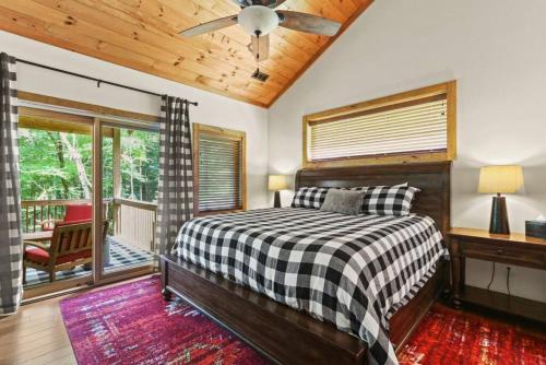 a bedroom with a bed and a wooden ceiling at Welcome to Padre's Mountain Paradise! in Blowing Rock
