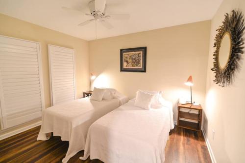 a bedroom with two beds and a ceiling fan at Mileys Place at Pinehurst in Pinehurst