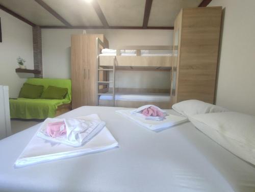 a bedroom with a bed with two towels on it at Kutak na Drini in Mali Zvornik