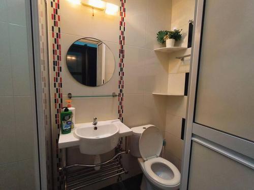 a small bathroom with a toilet and a sink at TheBliss8 八悦椋居 2R2B for 5-8pax in Melaka