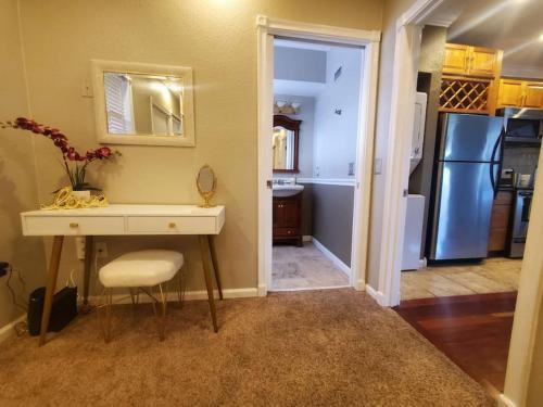 a kitchen with a table and a sink and a refrigerator at Romance in the City 1 Bdrm Studio in Downtown St Pete in St Petersburg