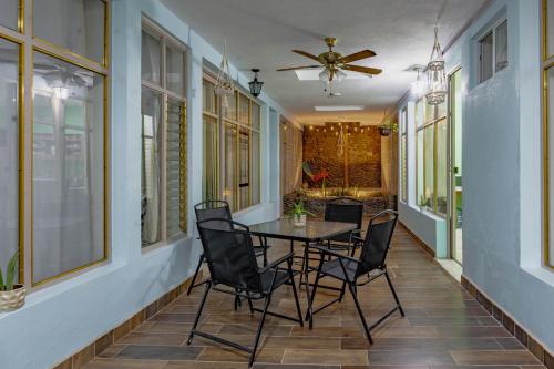 a dining room with a table and chairs on a porch at Casa Marina: Habitación Monterrey in Acámbaro