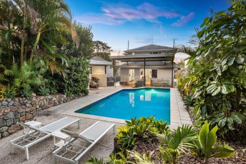 a swimming pool in the backyard of a house at Luxury holiday house Pool WIFI Airconditioning in Alexandra Headland