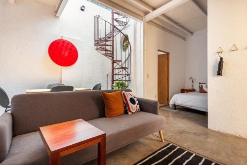a living room with a couch and a bed at Amazing loft w/ terrace in Mexico City Downtown in Mexico City